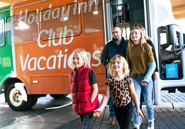 Family walking off shuttle at Desert Club Resort in Las Vegas, Nevada.