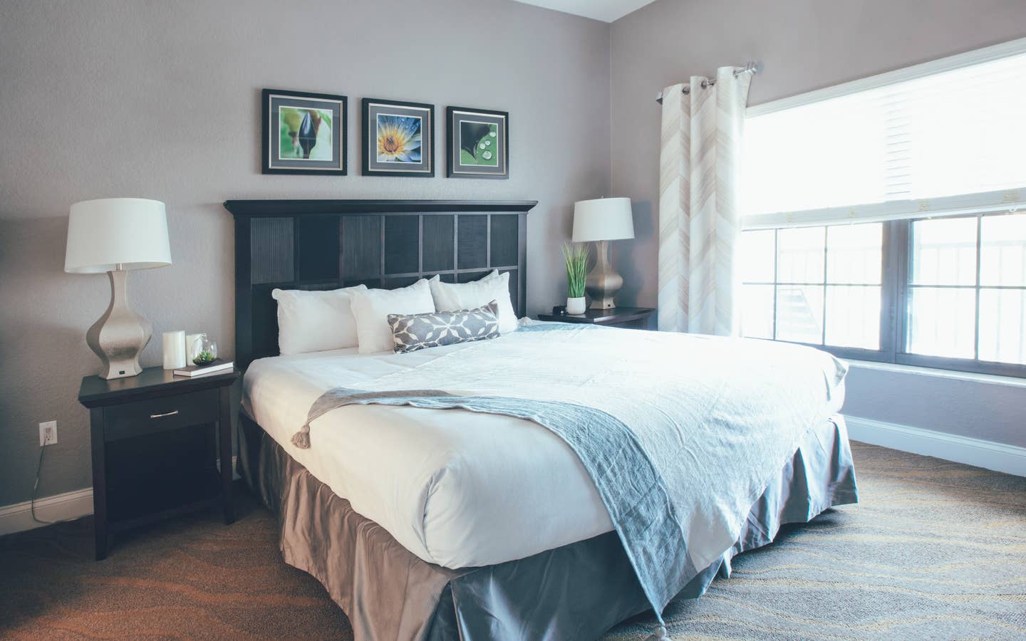 Bedroom with large window and two night stands in a one bedroom villa in North Village at Orange Lake Resort near Orlando, Florida