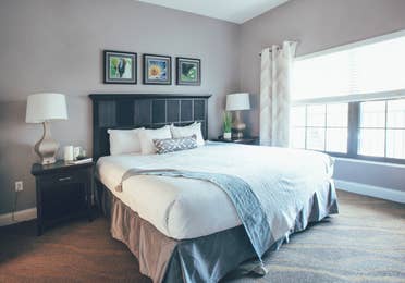 Bedroom with large window and two night stands in a one bedroom villa in North Village at Orange Lake Resort near Orlando, Florida