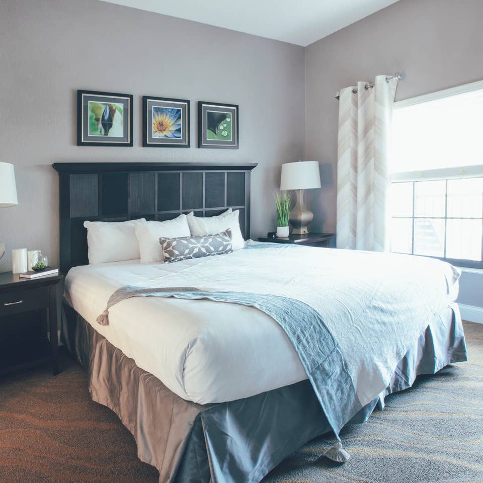 Bedroom with large window and two night stands in a one bedroom villa in North Village at Orange Lake Resort near Orlando, Florida