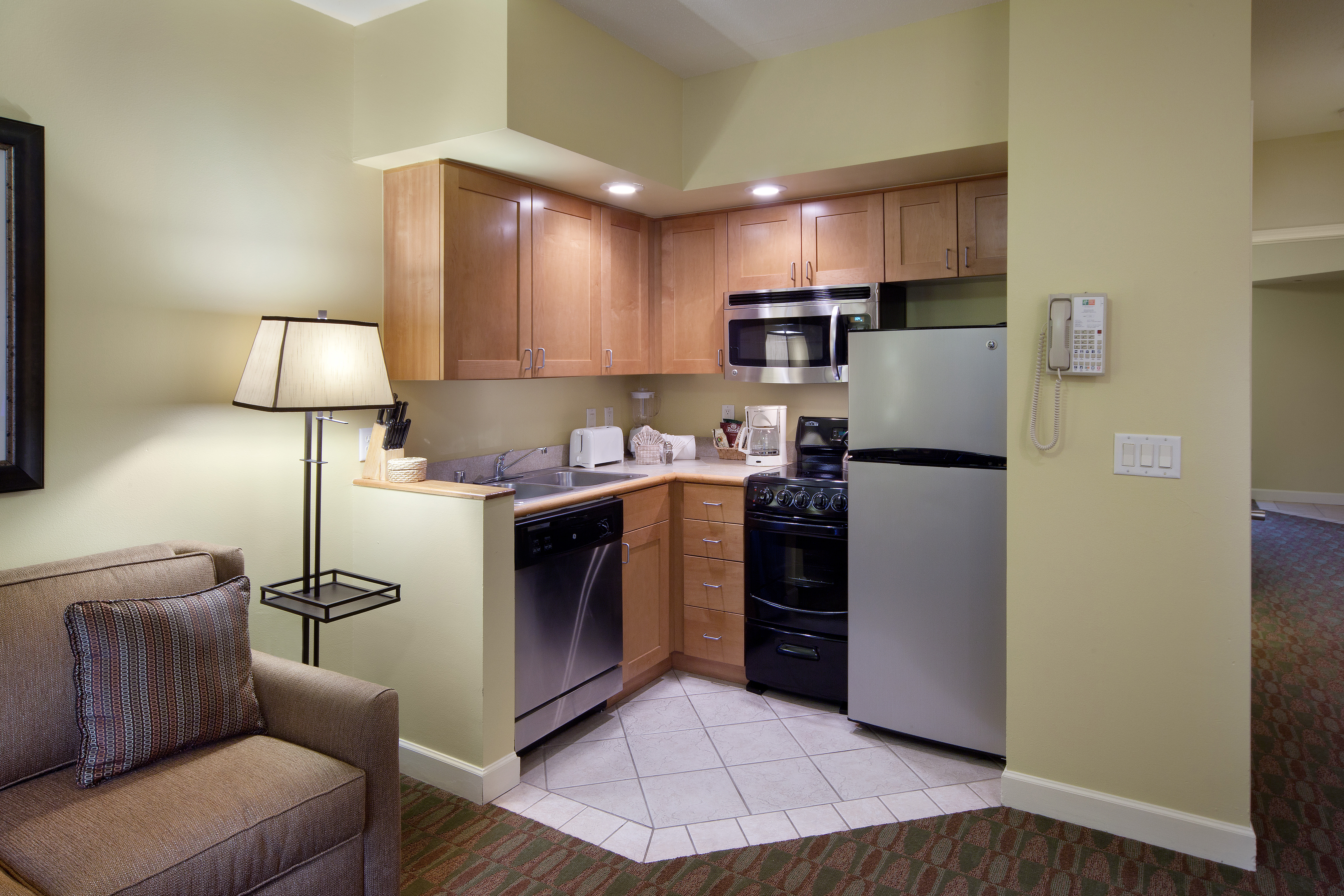 Kitchenette with stainless steel fridge, microwave, dishwasher, sink, and small oven in a villa at Lake Geneva Resort