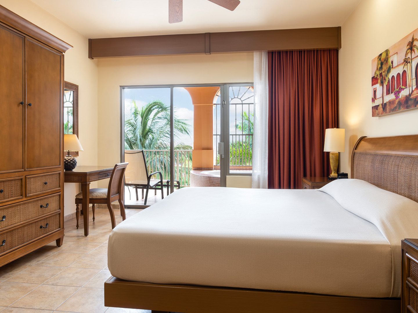 Large garden-view bedroom opening to a balcony with soaking tub.