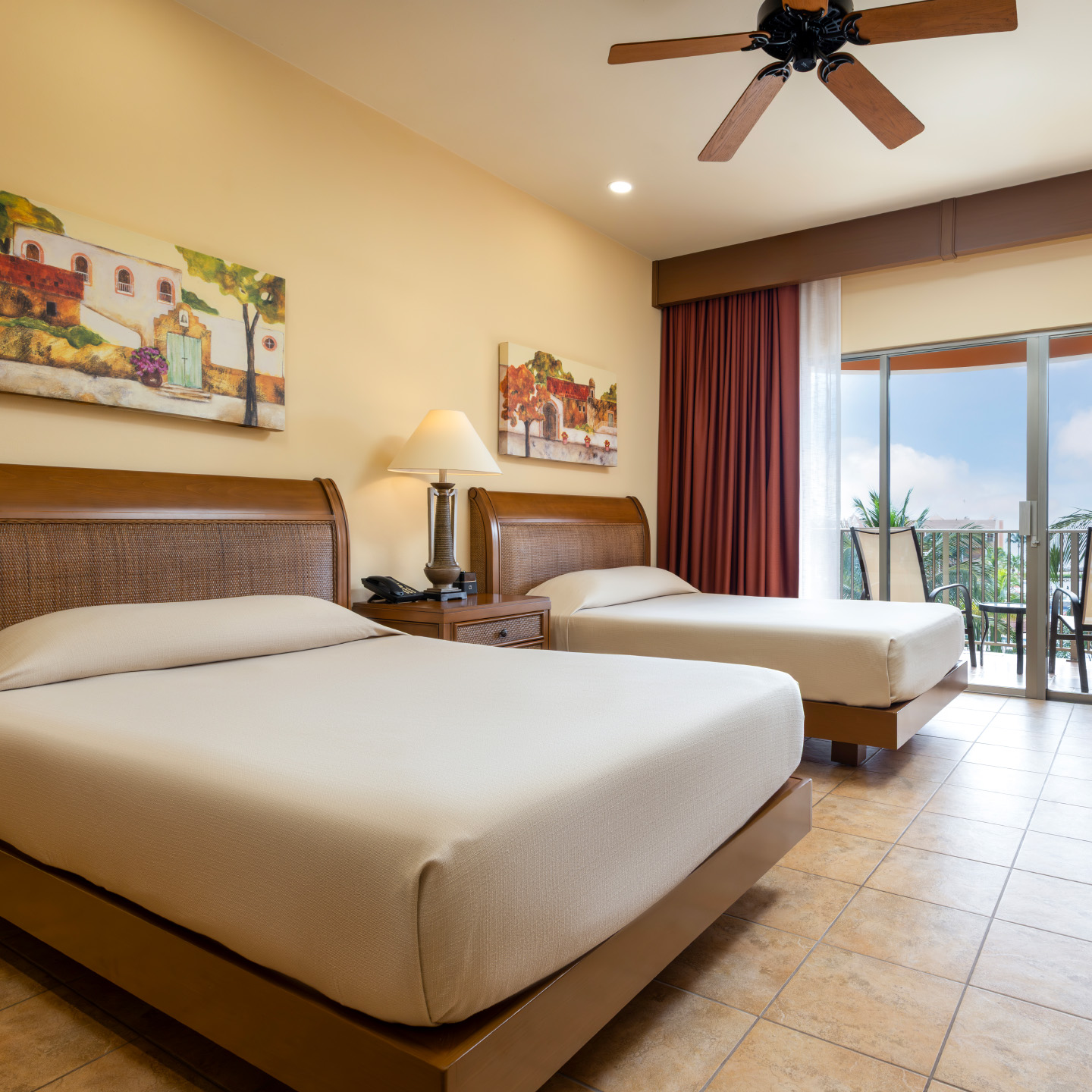 Oceanview bedroom with balcony and two comfortable beds.