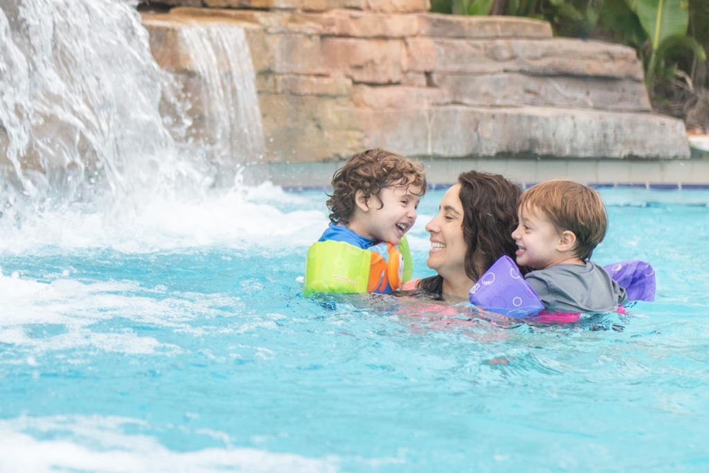 family swimming in pool