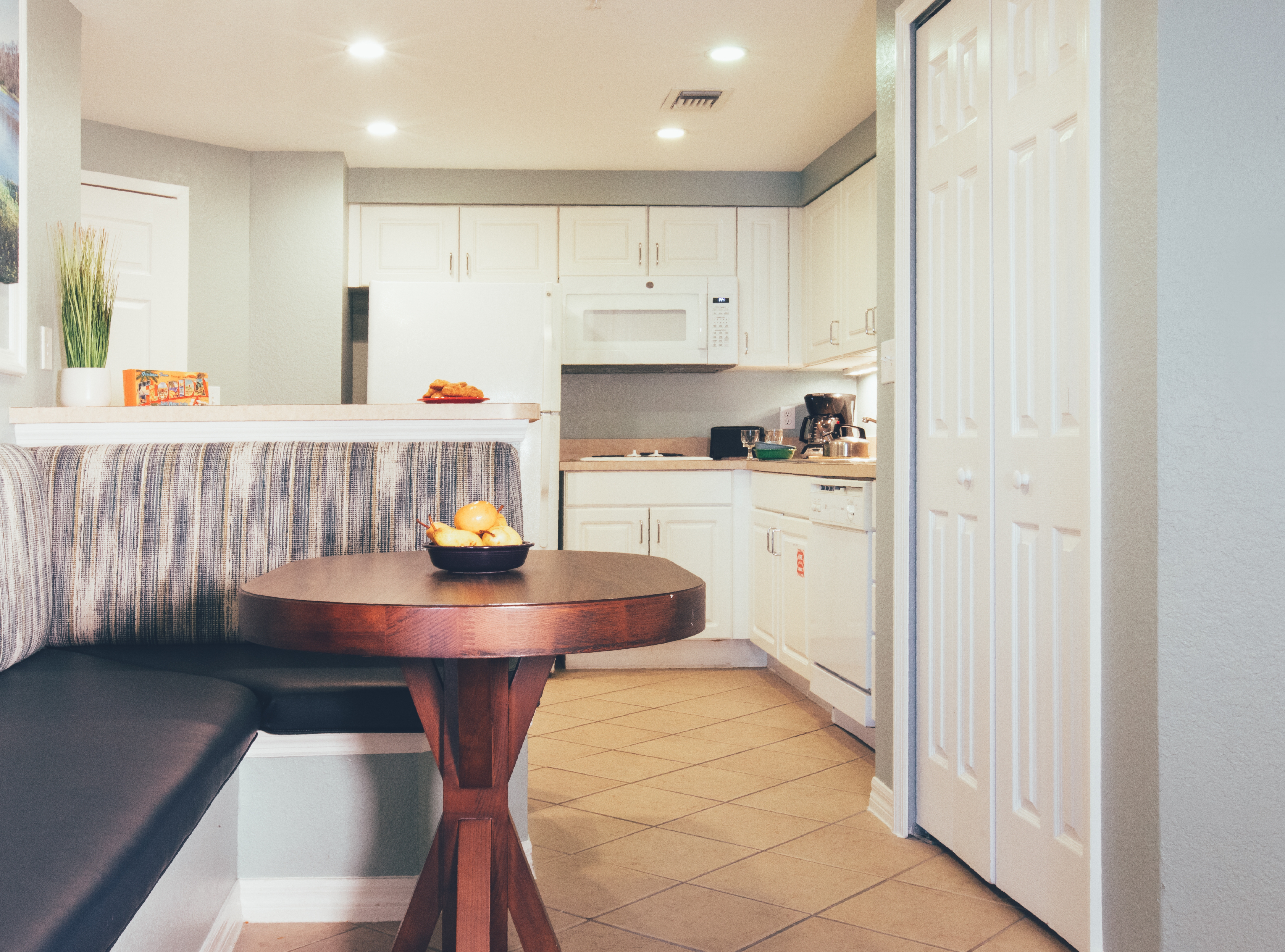 Dining area with full kitchen in background in a villa in River Island at Orange Lake Resort near Orlando, Florida