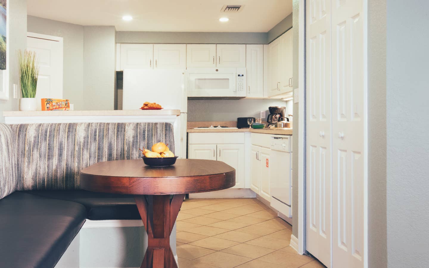 Dining area with full kitchen in background in a villa in River Island at Orange Lake Resort near Orlando, Florida