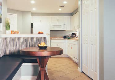 Dining area with full kitchen in background in a villa in River Island at Orange Lake Resort near Orlando, Florida