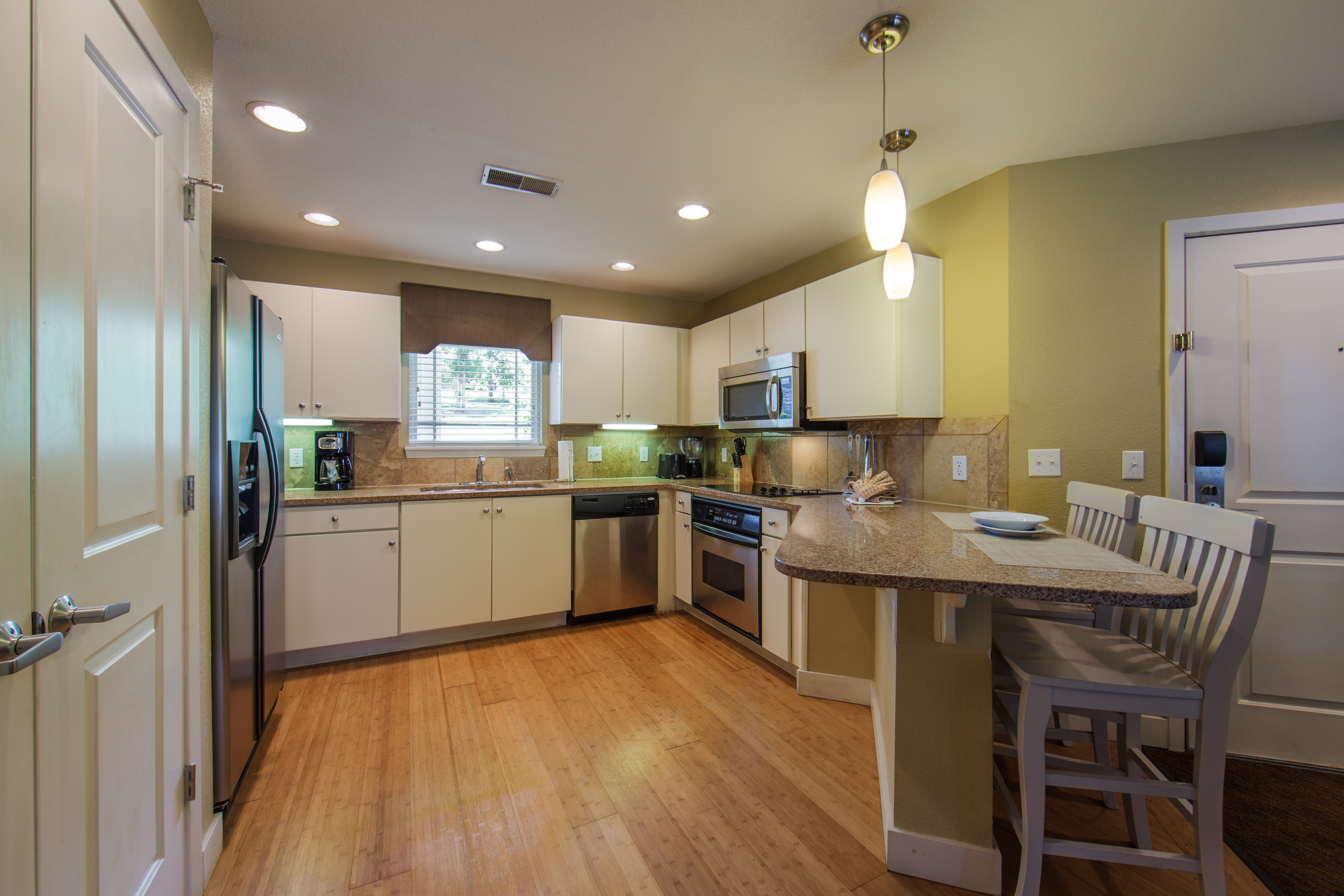 Kitchen with dining bar area in a two-bedroom ambassador villa at the Holiday Hills Resort in Branson Missouri.