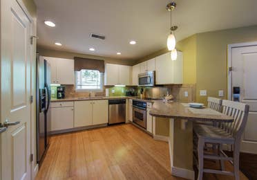 Kitchen with dining bar area in a two-bedroom ambassador villa at the Holiday Hills Resort in Branson Missouri.