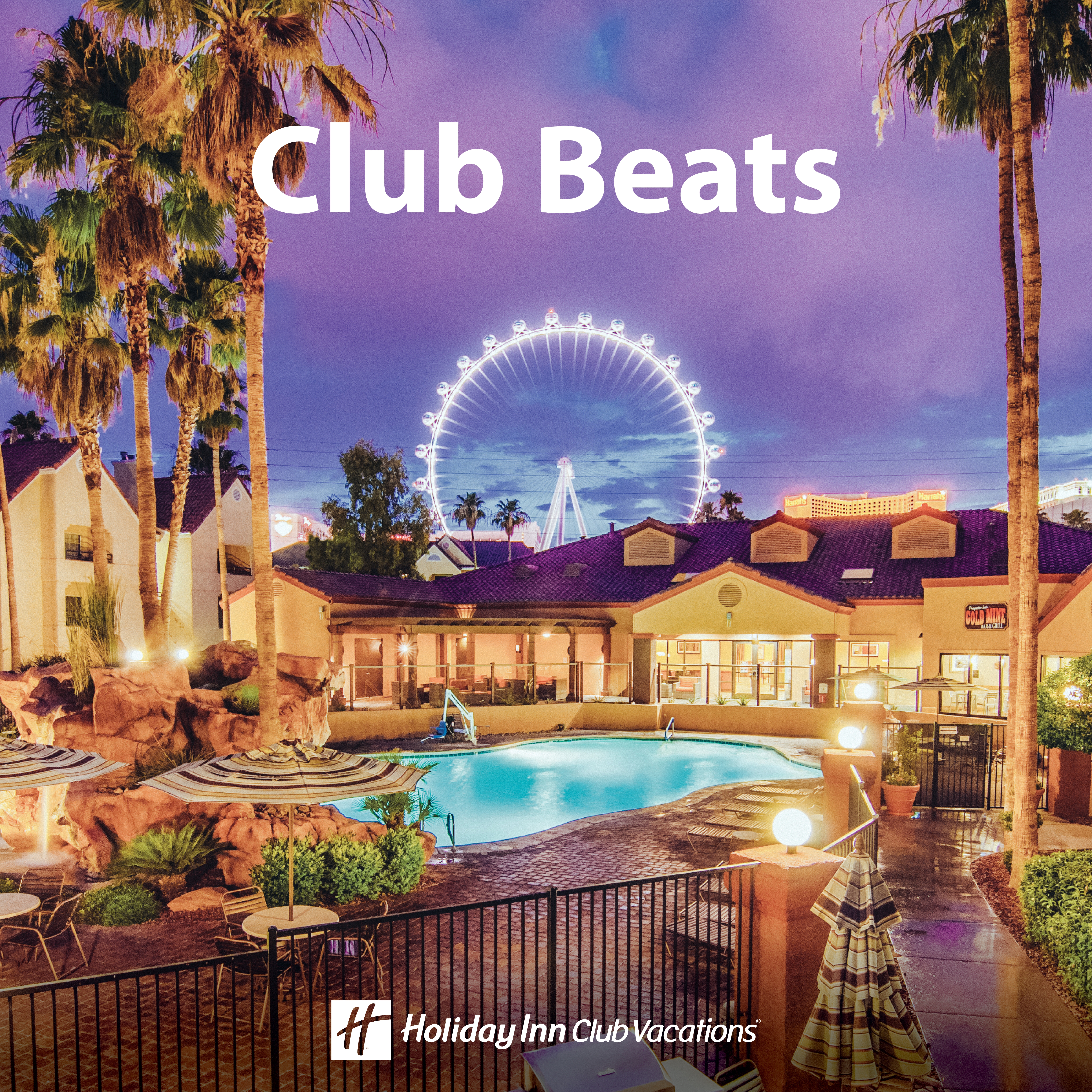 A nighttime shot of Desert Club Resort with the Las Vegas Observation Wheel in the background.