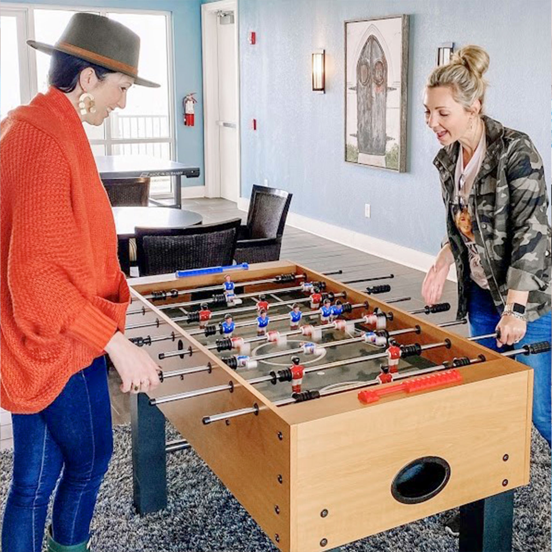 Featured Contributor, Amanda Nall (right) plays foosball with her friend at our Galveston Beach Resort in Galveston, Tx.