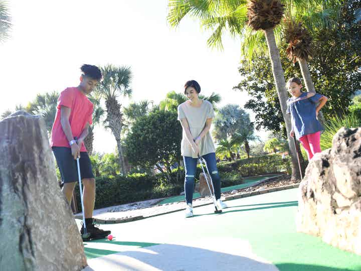 Family playing mini golf at Cape Canaveral Beach Resort.