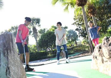 Family playing mini golf at Cape Canaveral Beach Resort.