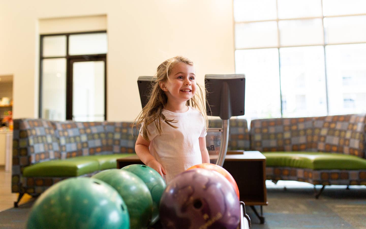 Young child bowling at Williamsburg Resort.
