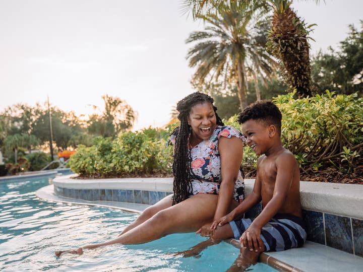Mother and son sitting on edge of pool at Orange Lake Resort near Orlando, Florida.