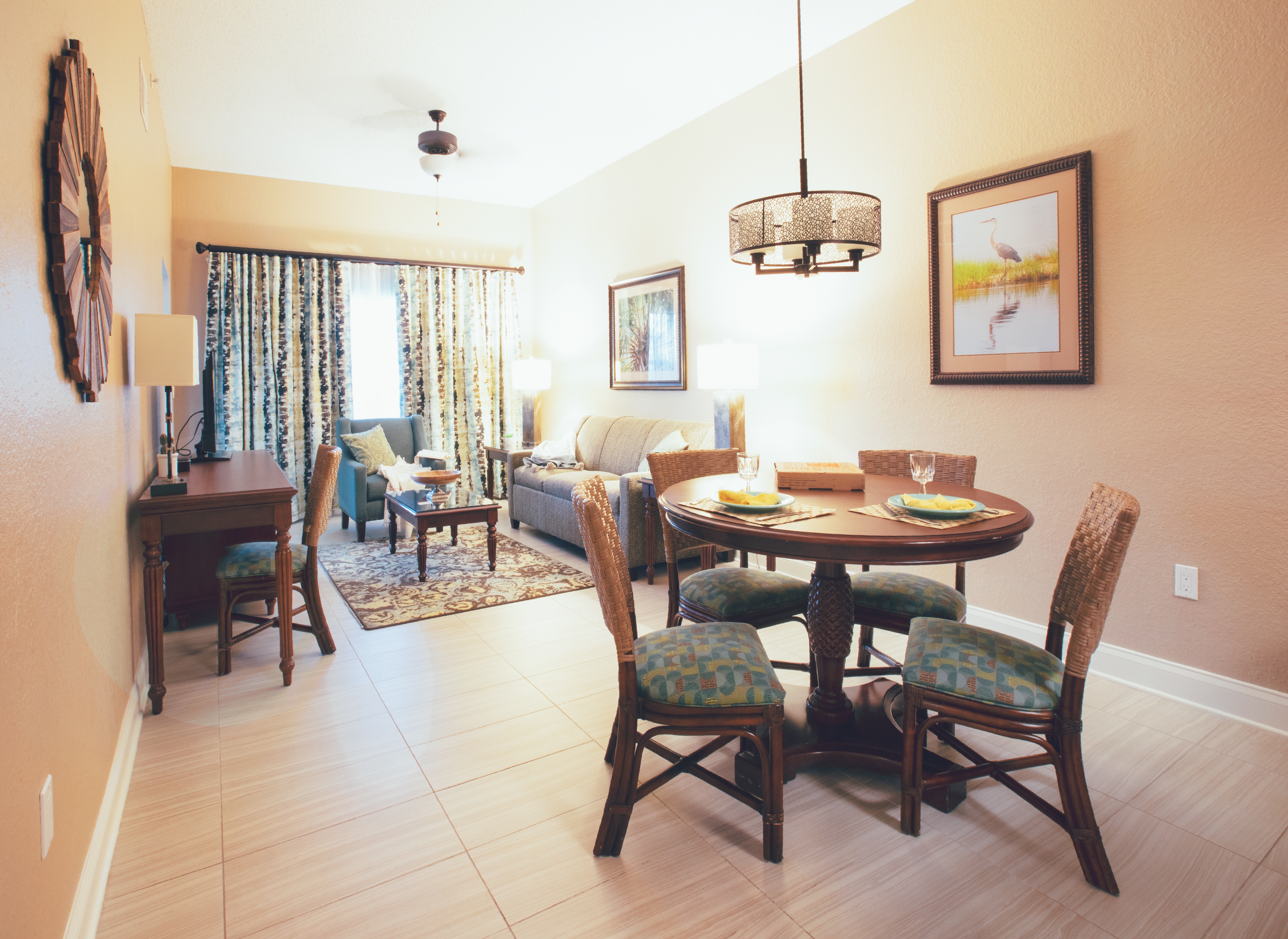 View of dining table and living room in a one bedroom villa in North Village at Orange Lake Resort near Orlando, Florida