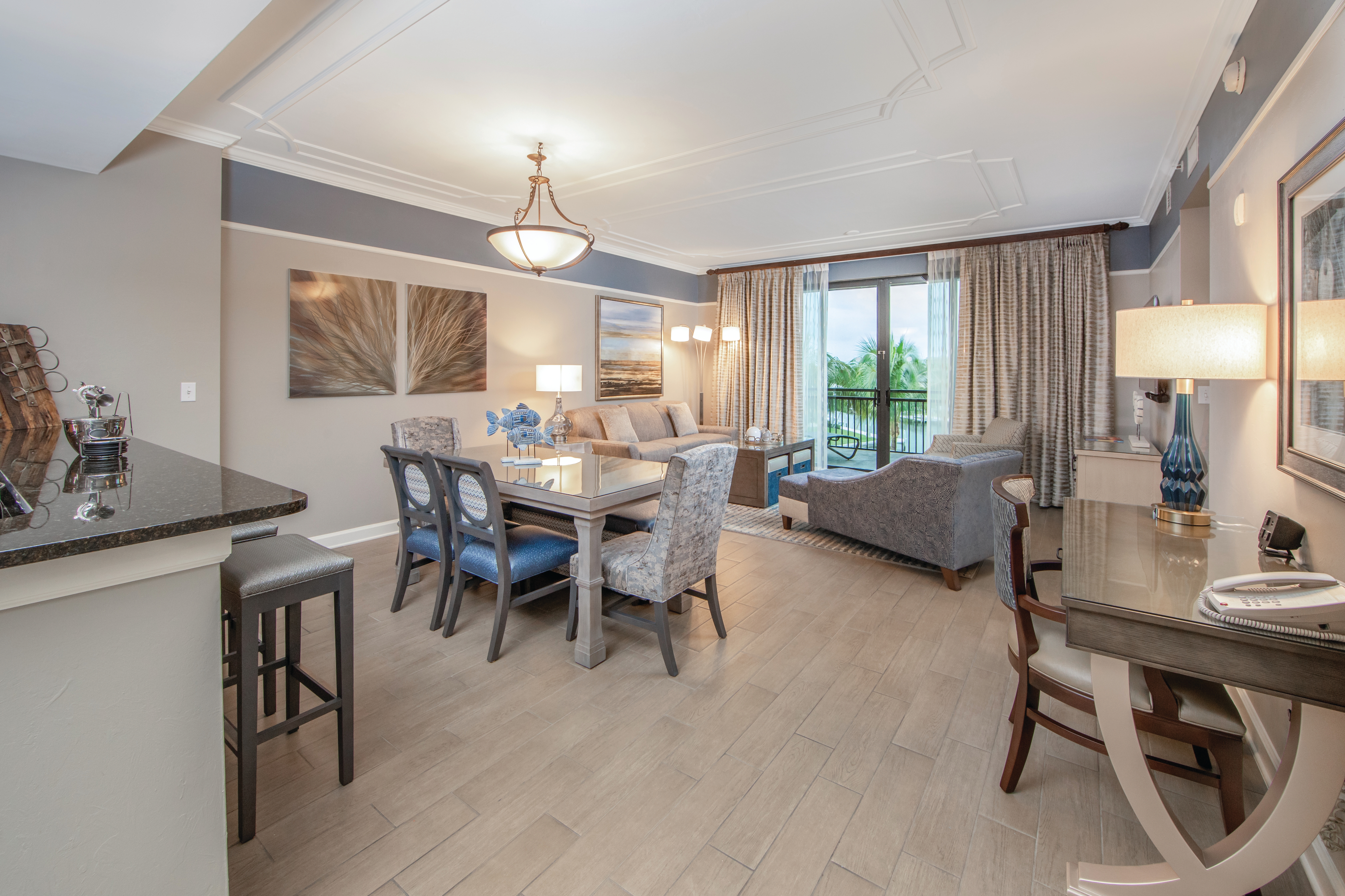 Entire room view with desk, dining room table, and living room in a three-bedroom villa at Sunset Cove Resort in Marco Island, Florida