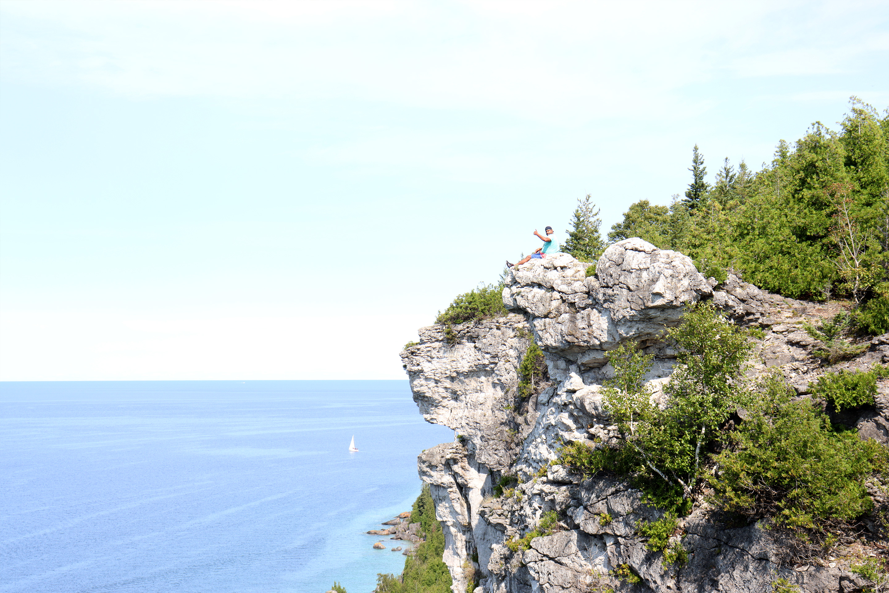 Rohan sits upon the Lions Head lookout under a blue sky.