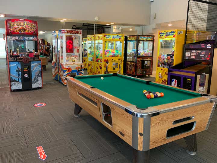 Game room with pool table and arcade games at Desert Club Resort in Las Vegas, Nevada.