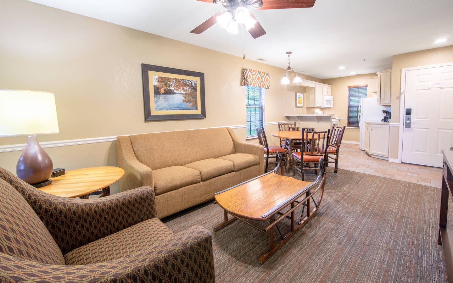 Living room, dining and kitchen area in a two-bedroom lodge villa at Fox River Resort in Sheridan, Illinois.