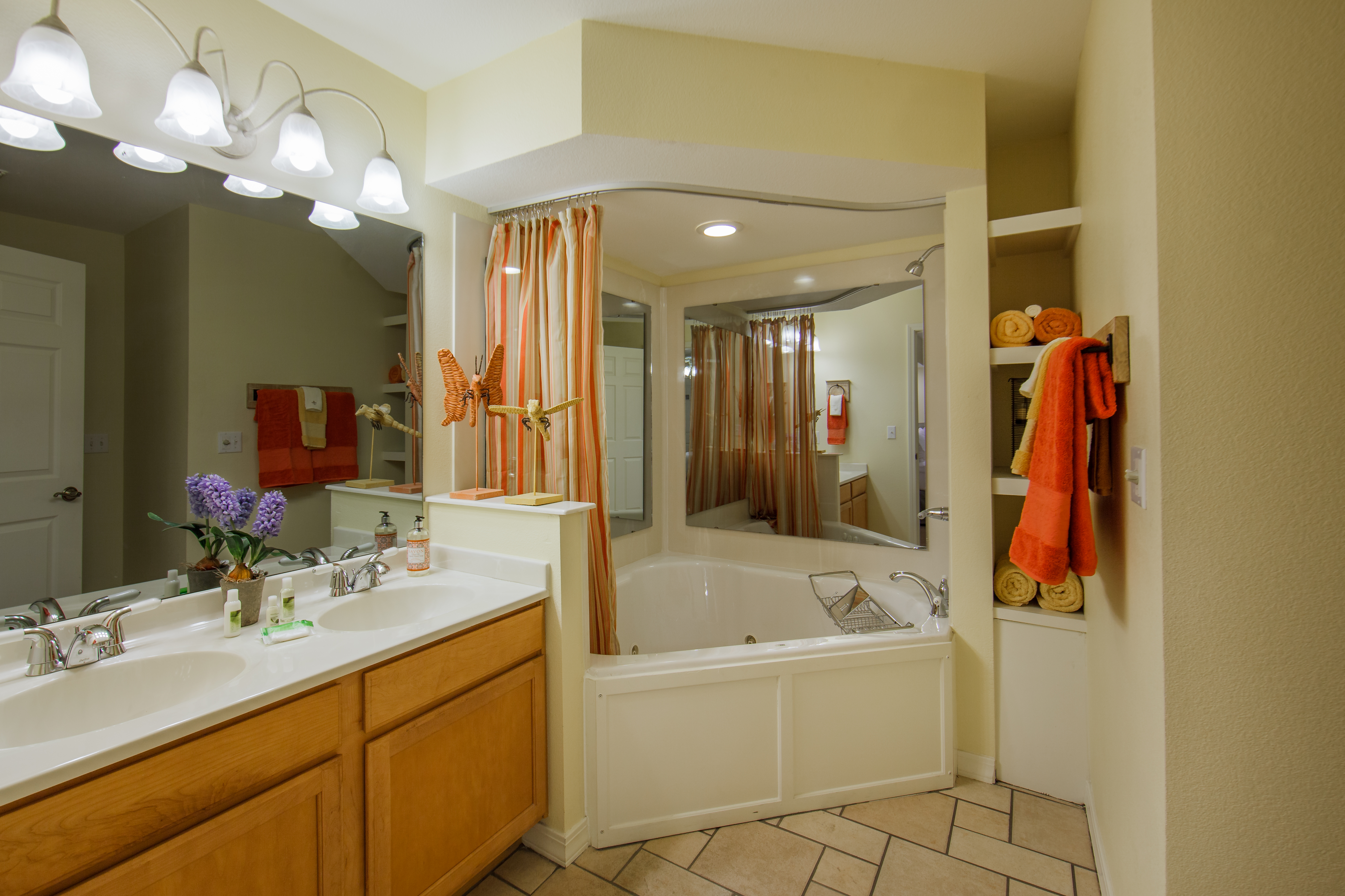 Bathroom with two-sink vanity and garden tub in a two-bedroom presidential villa at the Holiday Hills Resort in Branson Missouri.