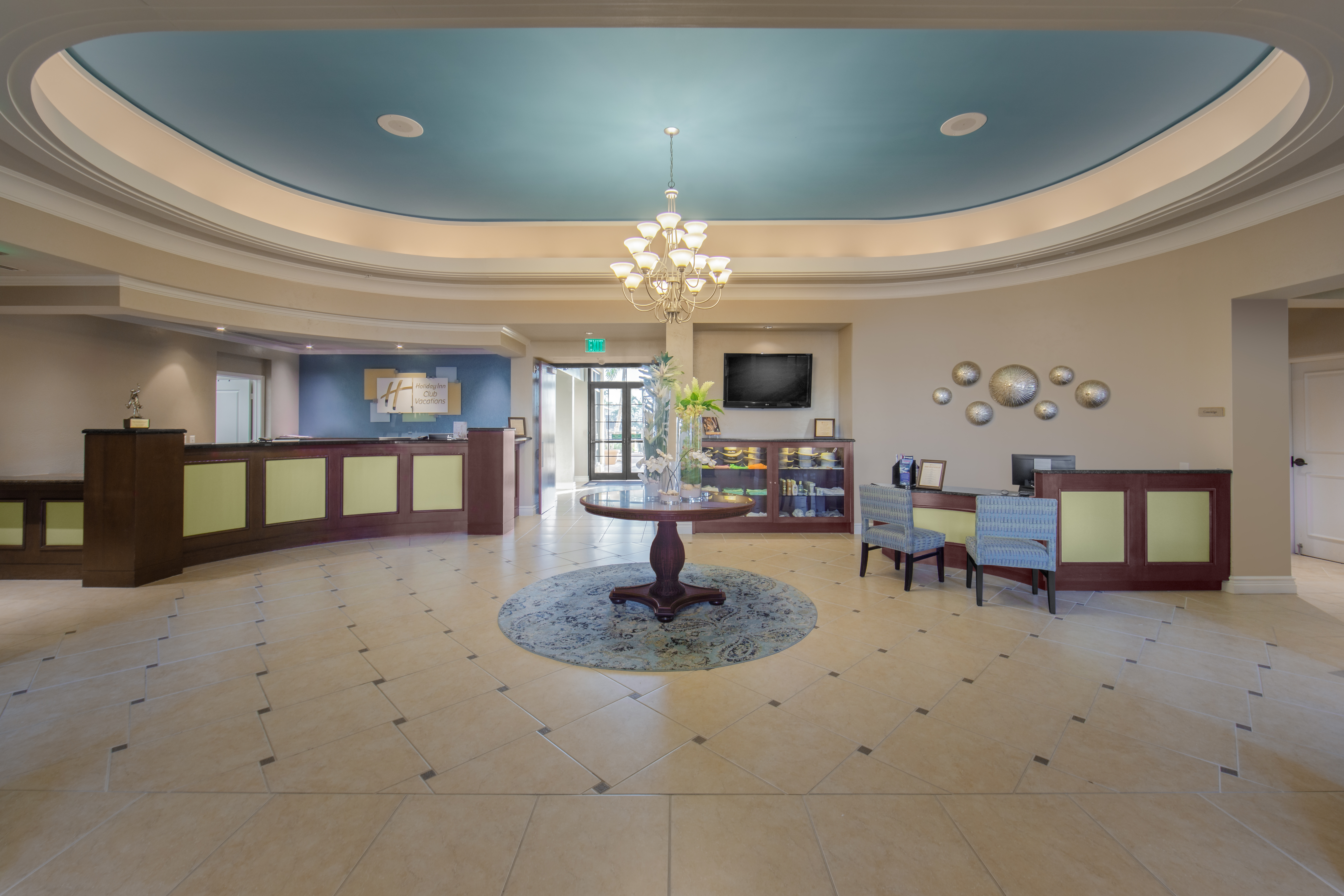Lobby view with front desk and comfortable seating area at Sunset Cove Resort in Marco Island, Florida.
