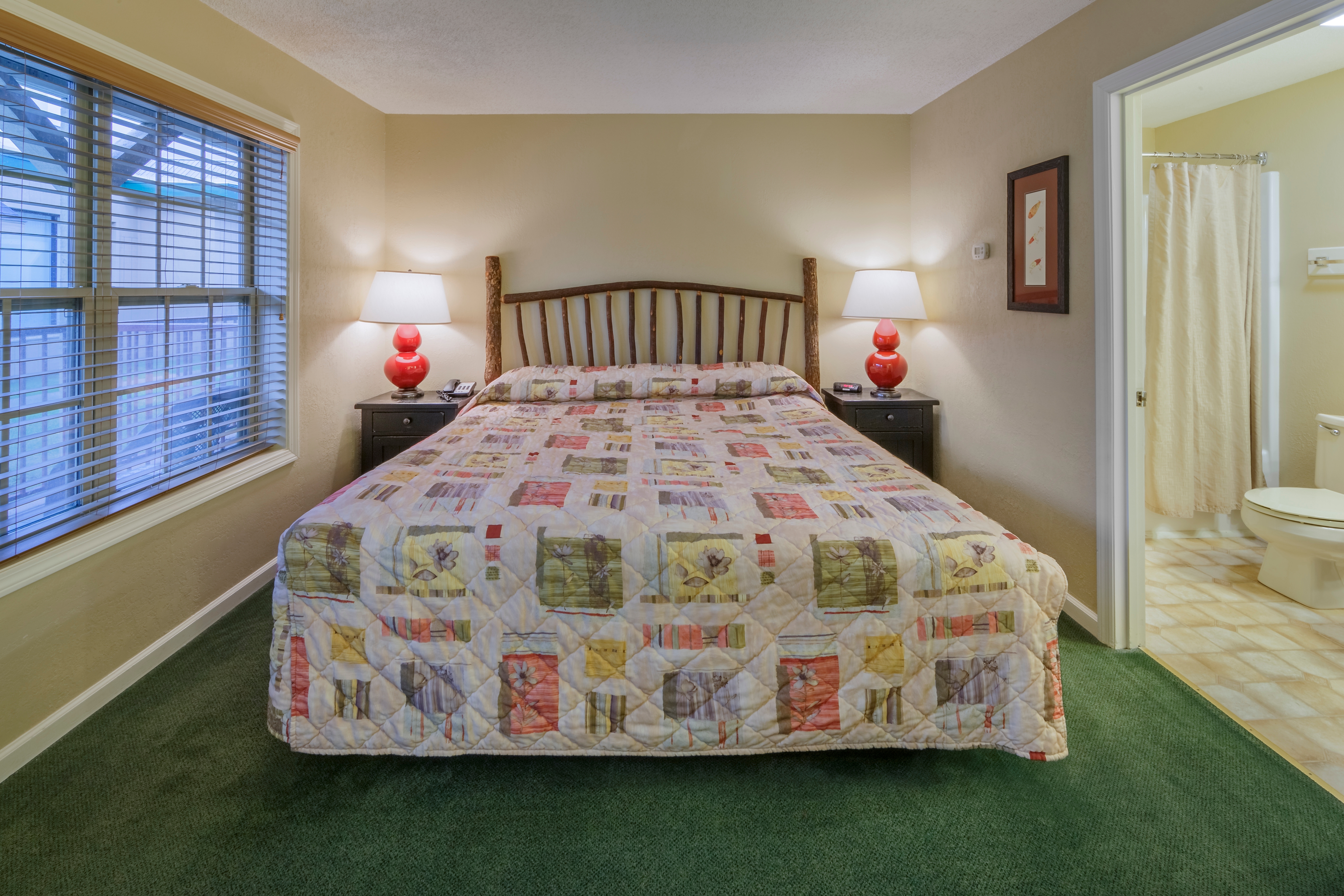 King bed in a bedroom of a three bedroom villa at Oak n' Spruce Resort in South Lee, Massachusetts