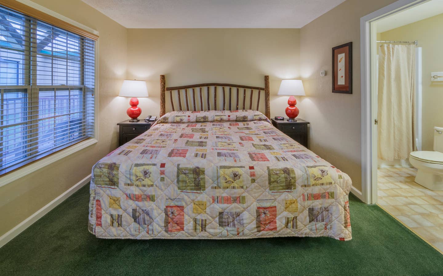 King bed in a bedroom of a three bedroom villa at Oak n' Spruce Resort in South Lee, Massachusetts