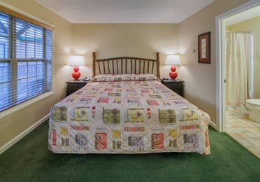 King bed in a bedroom of a three bedroom villa at Oak n' Spruce Resort in South Lee, Massachusetts
