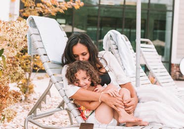 Mother and daughter sitting in a pool chair at Williamsburg Resort in Virginia.