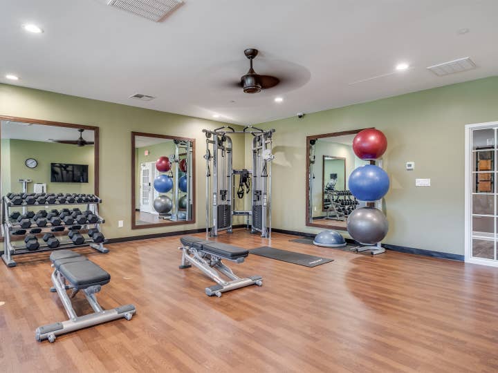 Fitness center with yoga balls and free weights at Piney Shores Resort in Conroe, Texas.