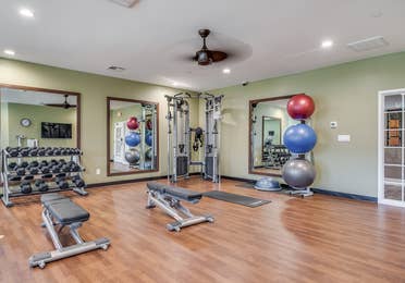 Fitness center with yoga balls and free weights at Piney Shores Resort in Conroe, Texas.