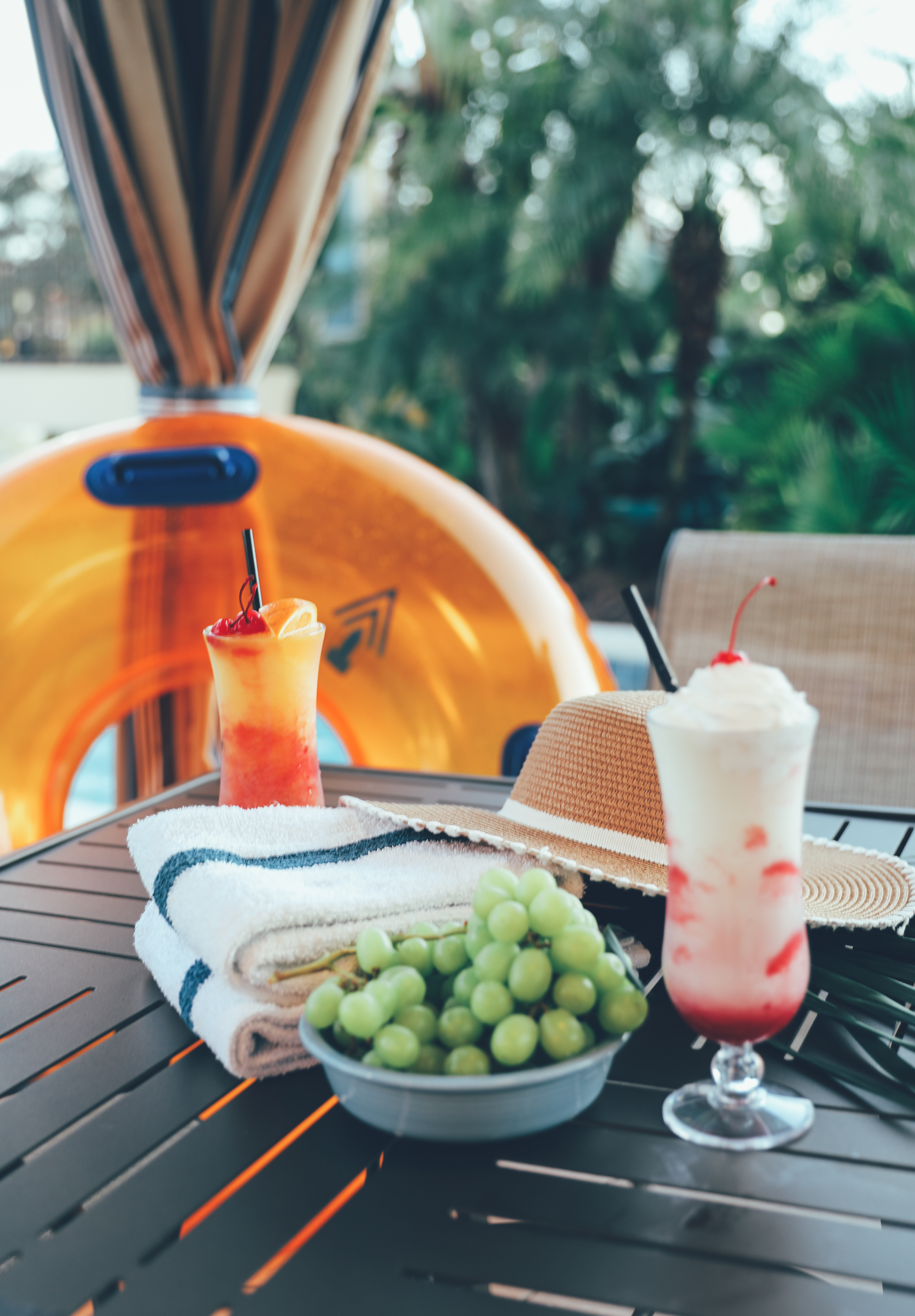 Bowl of grapes and two fruity beverages on a table in River Island at Orange Lake Resort near Orlando, Florida