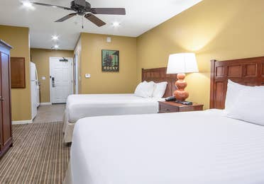 Two beds and a flat screen TV in a studio villa at Fox River Resort in Sheridan, Illinois.