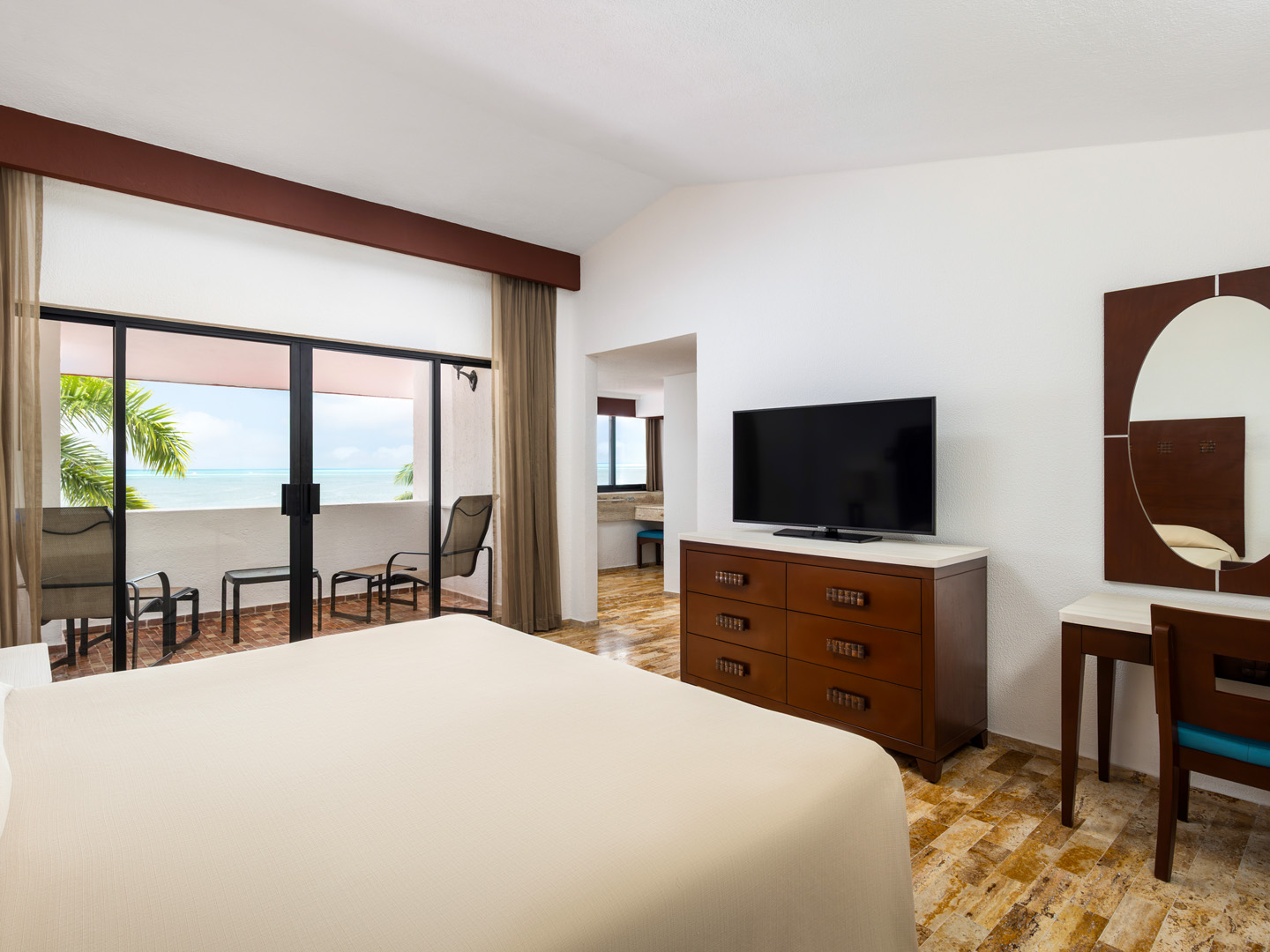 Oceanview villa bedroom with two beds and balcony access.