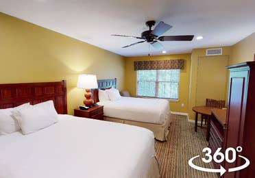 Bedroom with two beds in a studio villa at Fox River Resort in Sheridan, Illinois.