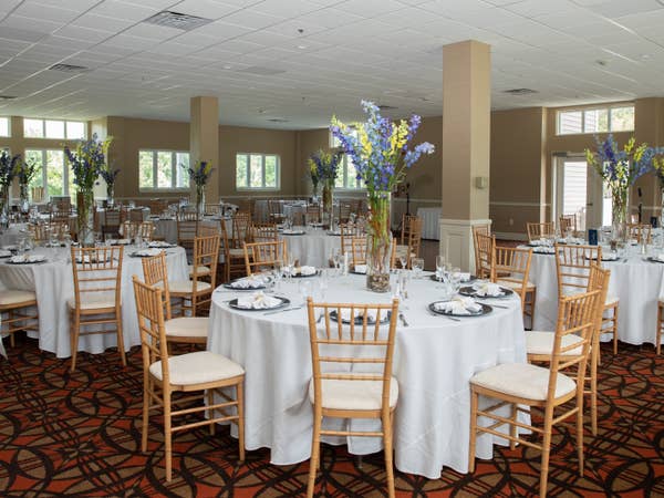 Round tables with white table cloths and place settings at Mount Ascutney Resort in Brownsville, Vermont.
