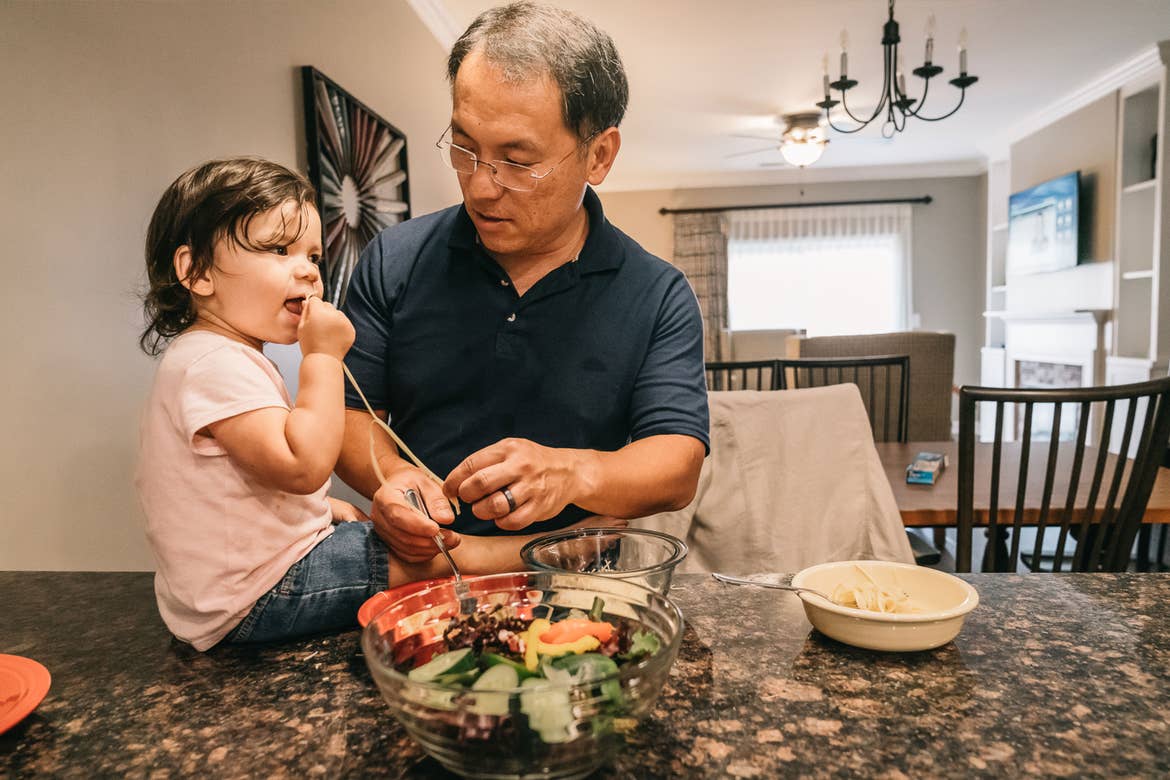Featured Contributor, Angelica Kajiwara's husband (right), and their daughter prep food in the villa kitchen of our Williamsburg resort in Williamsburg, Virginia.
