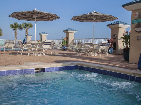 Outdoor pool with covered seating at Panama City Beach Resort in Florida.