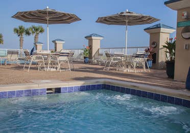 Outdoor pool with covered seating at Panama City Beach Resort in Florida.