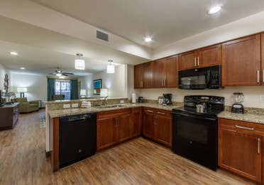 Full kitchen with oven, microwave, sink, dishwasher, and fridge in a one-bedroom villa at Scottsdale Resort