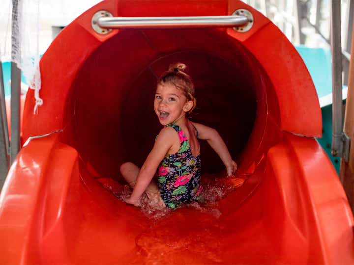 Small child preparing to go down waterslide at The Waterpark at The Villages at Villages Resort in Flint, Texas.