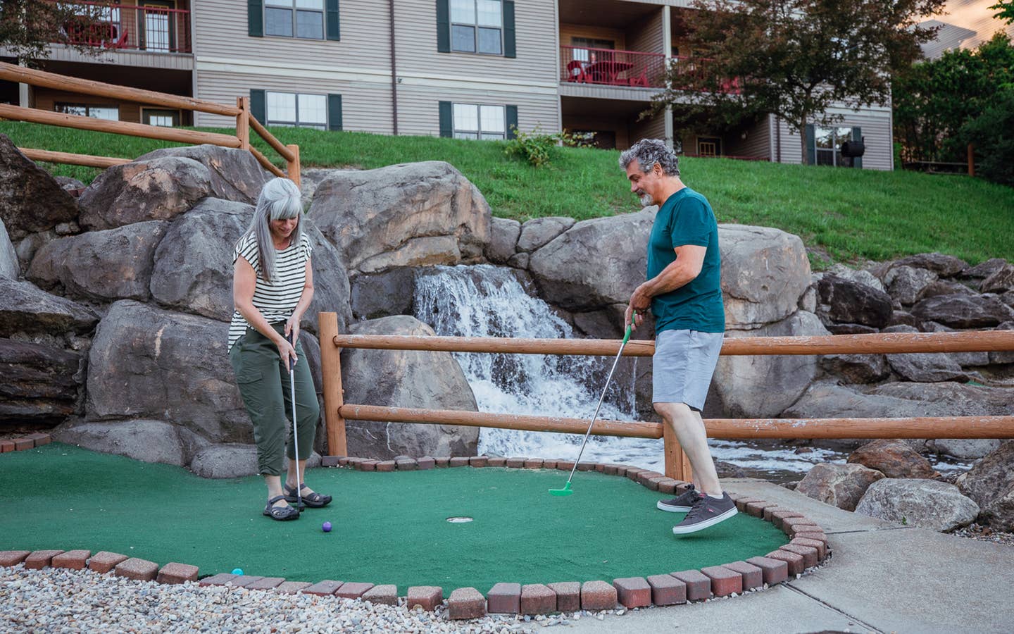 A couple playing mini golf at Oak n' Spruce Resort in South Lee, Massachusetts.