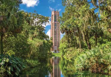 Tall brick building on lake among trees near Orange Lake Resort in Orlando, Florida