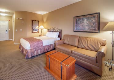 One queen bed and a sleeper sofa in a studio room at David Walley's Resort in Genoa, Nevada