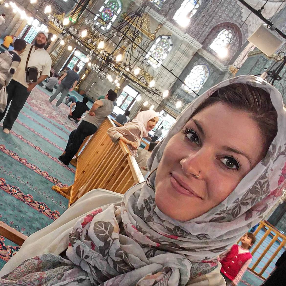Featured Contributor, Ashlyn George, wears a culturally-appropriate headscarf at a mosque in Istanbul.