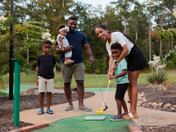 Family playing mini golf.