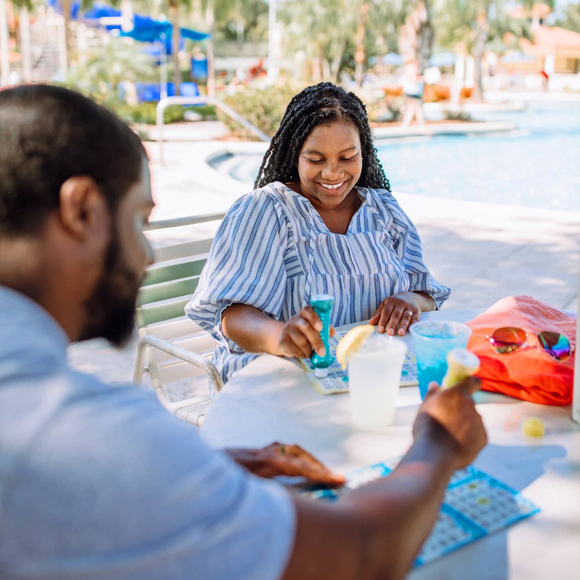 Krystin Godfrey (right) and her husband (left) enjoy a round of bingo poolside in River Island at our Orange Lake Resort located in Orlando, FL.