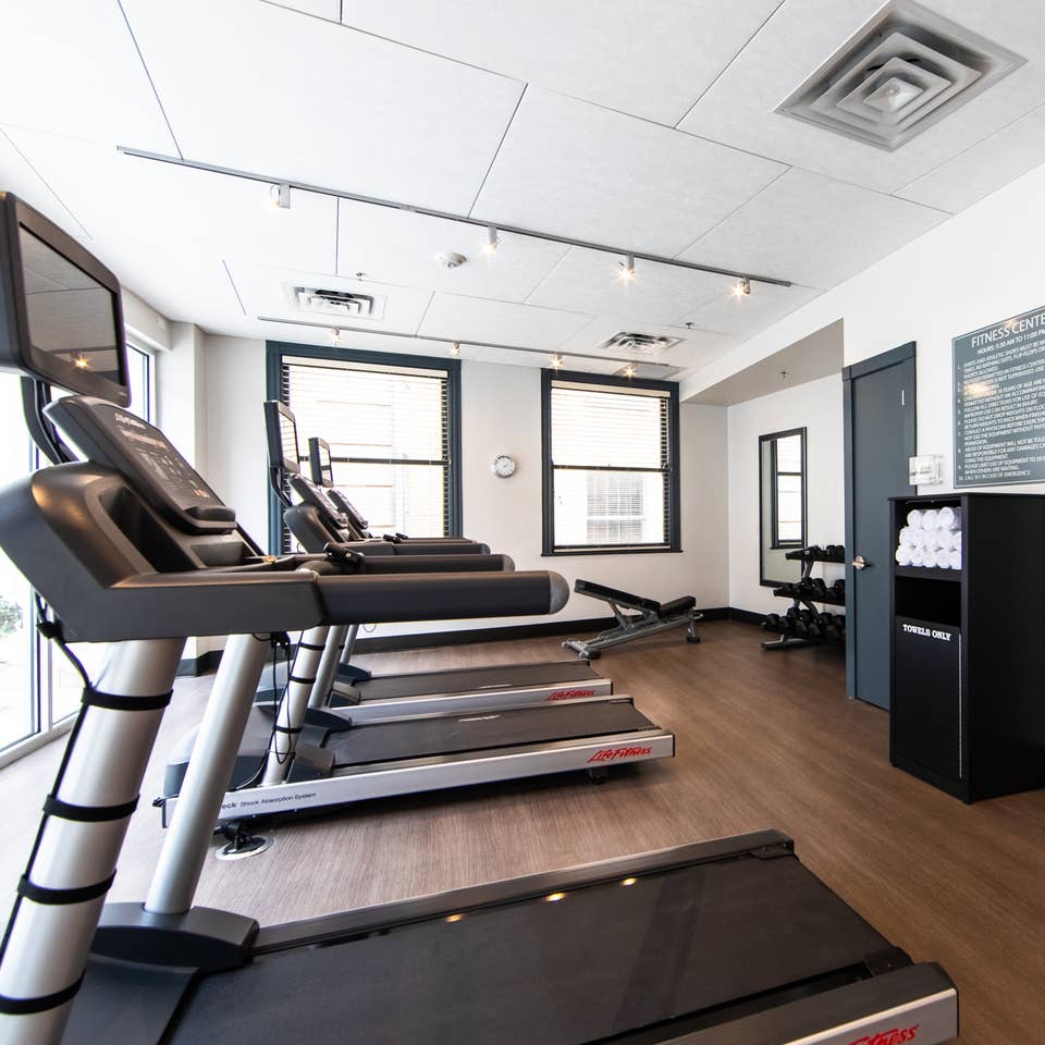 Fitness center with treadmills and free weights at New Orleans Resort in Louisiana.