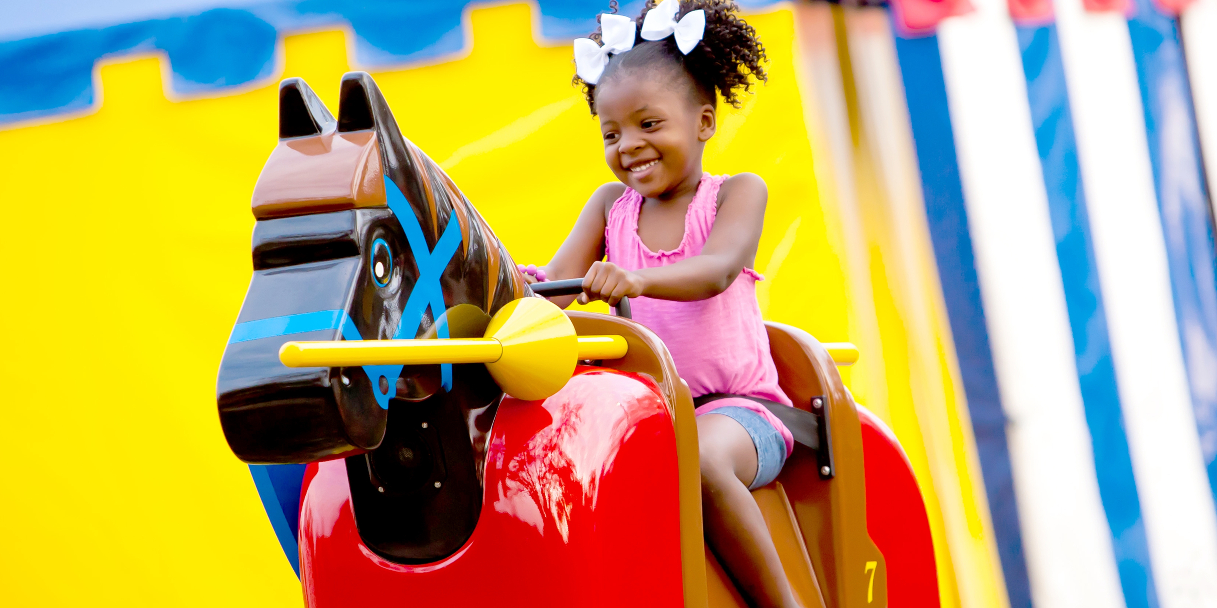 Small child riding mechanical horse at LEGOLAND Florida